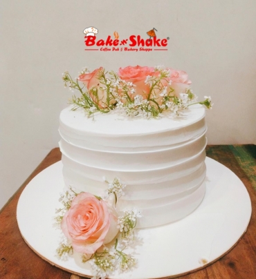 A CAKE WITH BEAUTIFUL FLOWERS