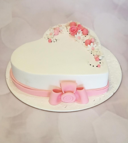 HEART SHAPE CAKE WITH PINK BOW ON IT 